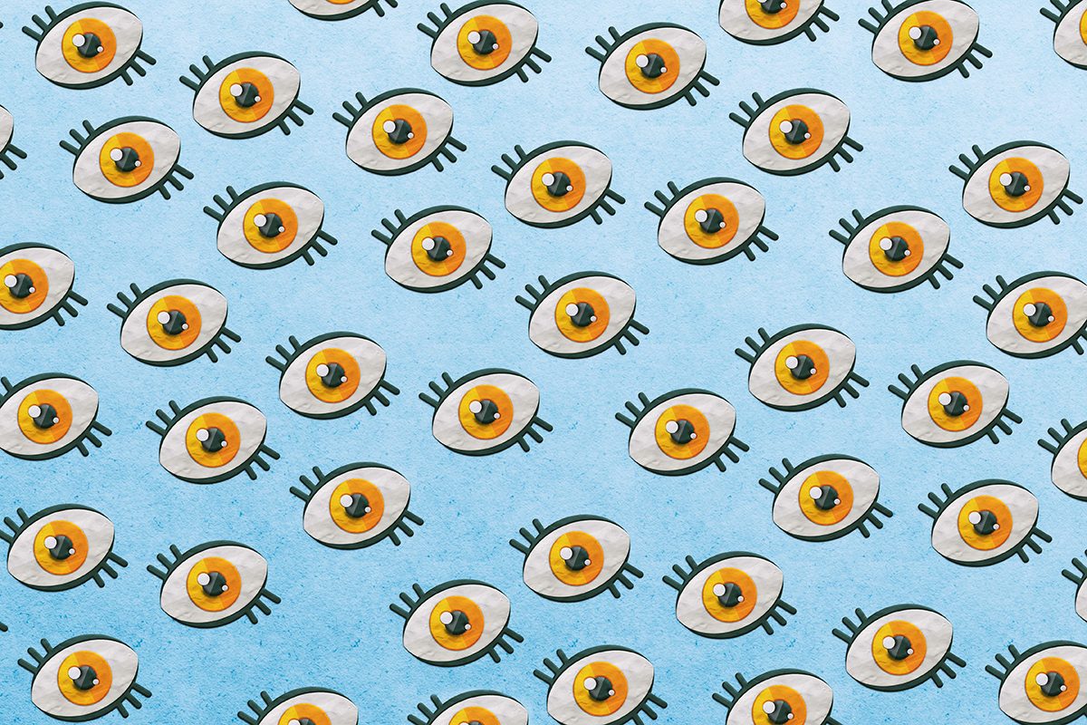 A pattern of orange eyes on a blue background