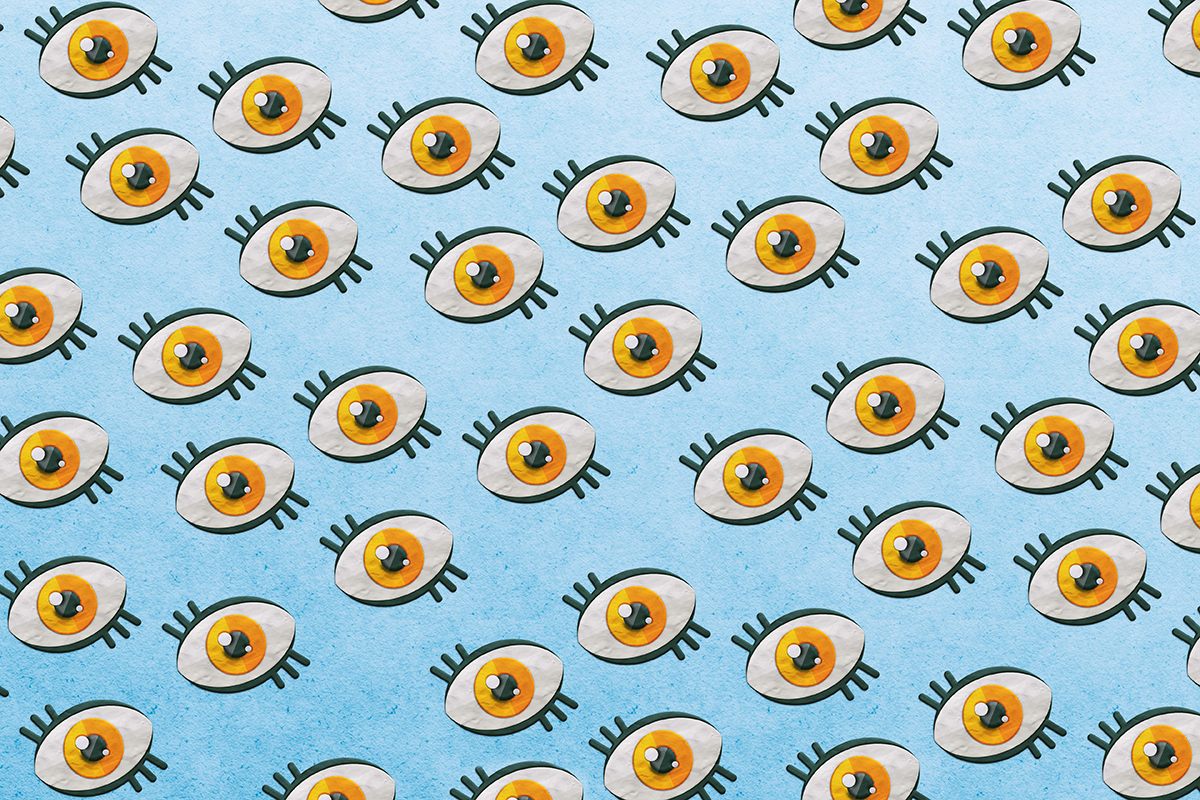 A pattern of orange eyes on a blue background