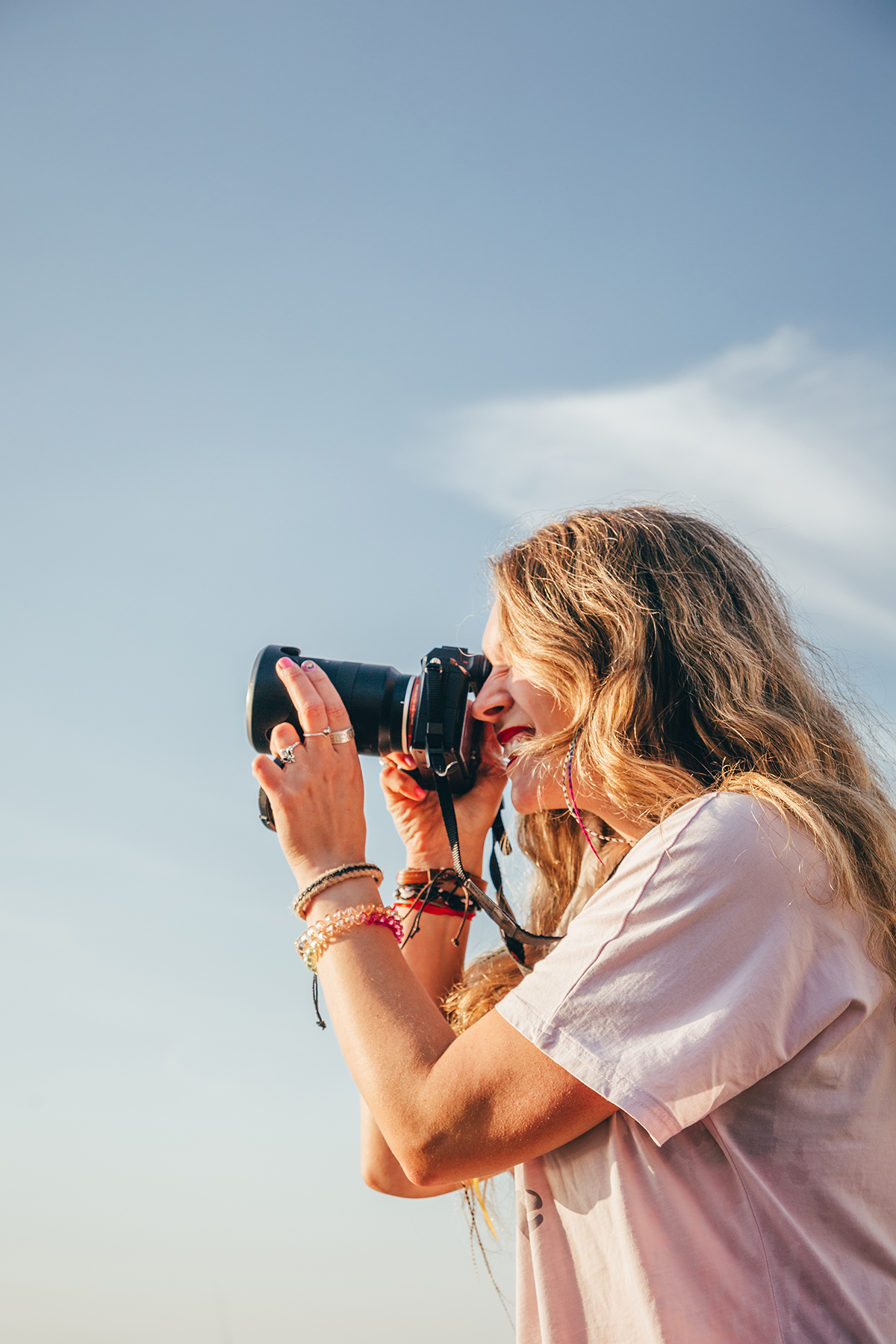 A woman taking a photo on a camera outdoors
