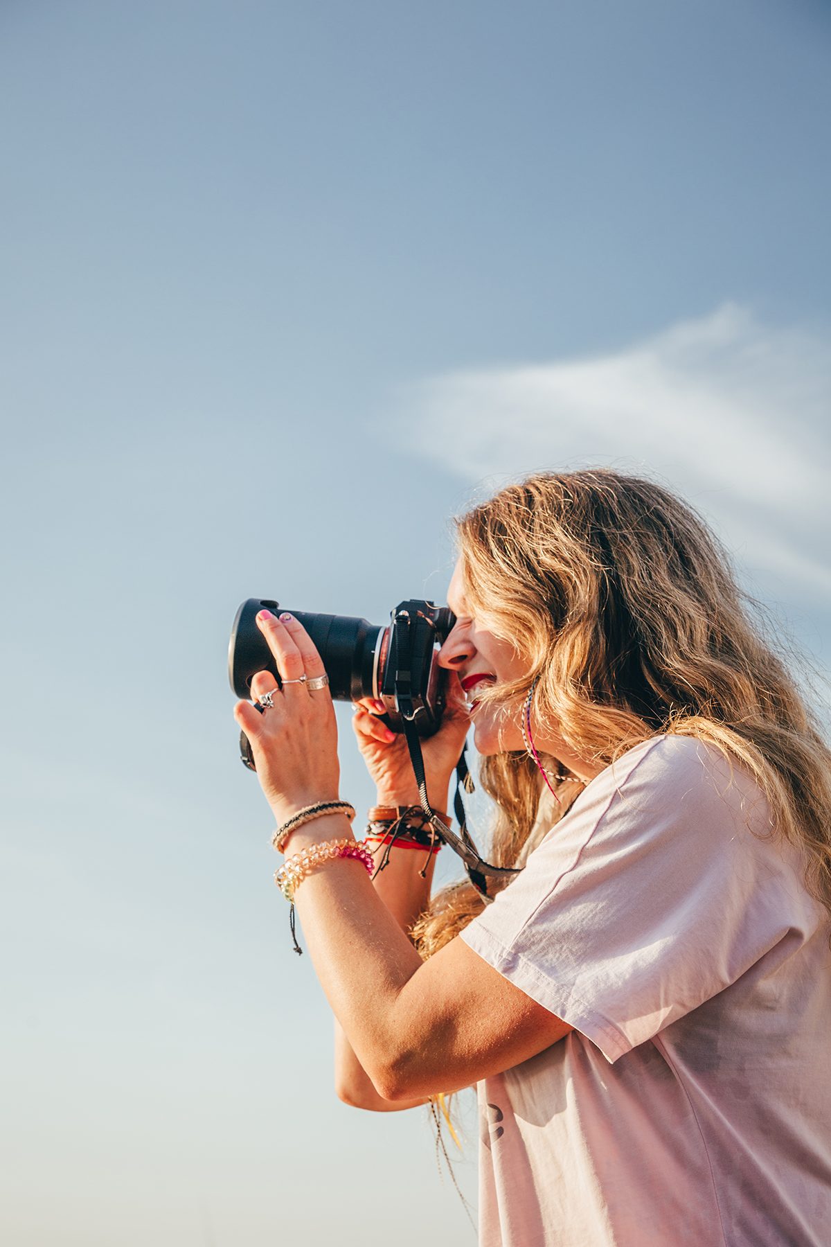A woman taking a photo on a camera outdoors