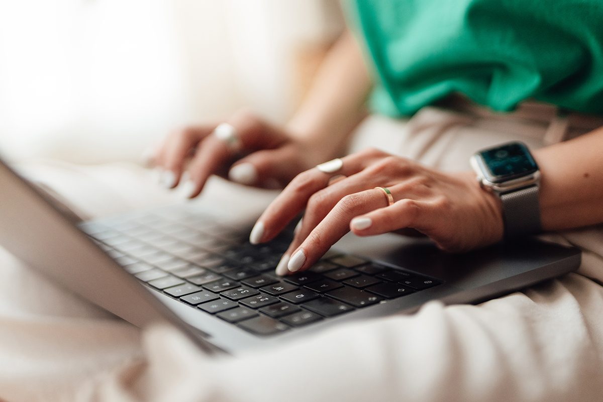 A woman typing on a laptop