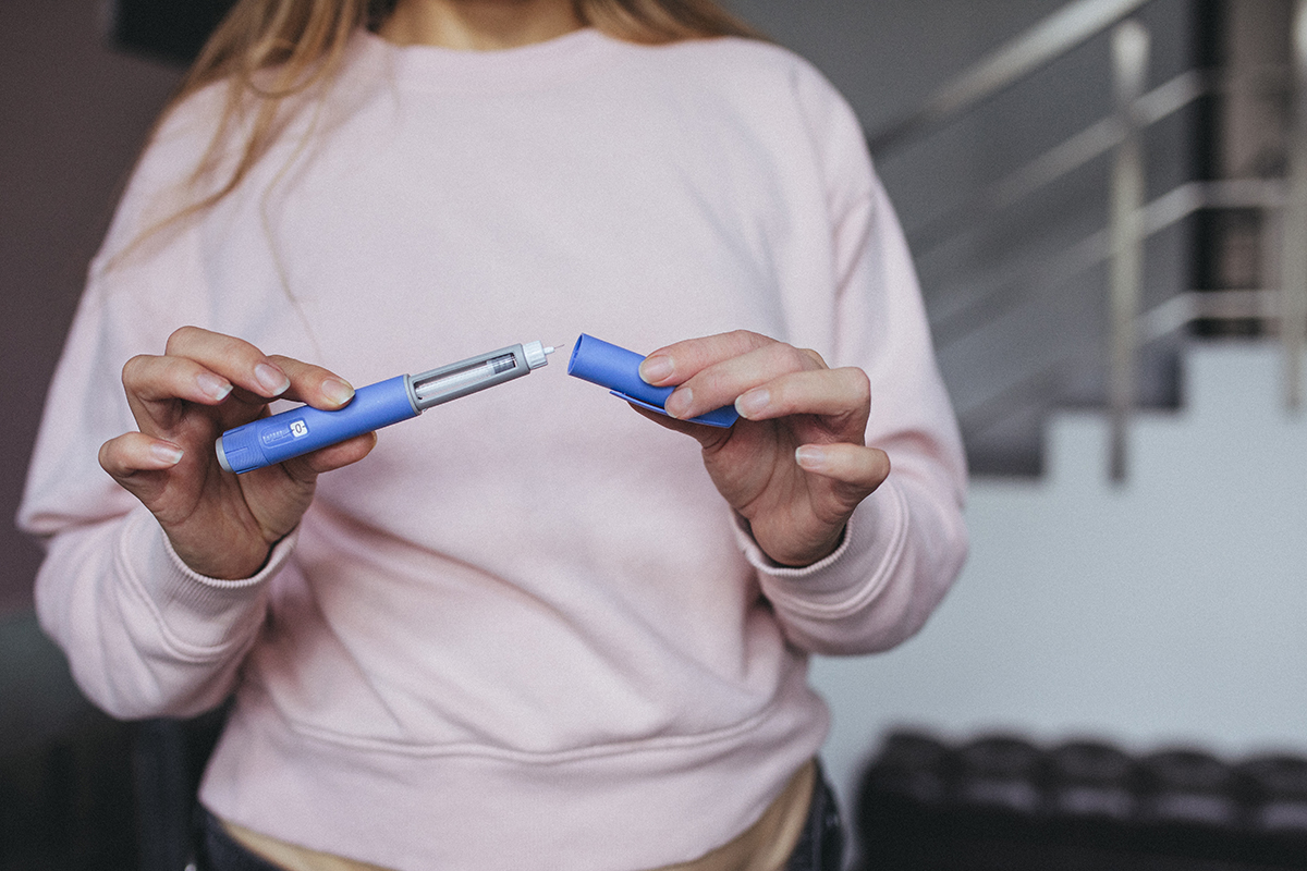A woman prepares a semaglutide pen.