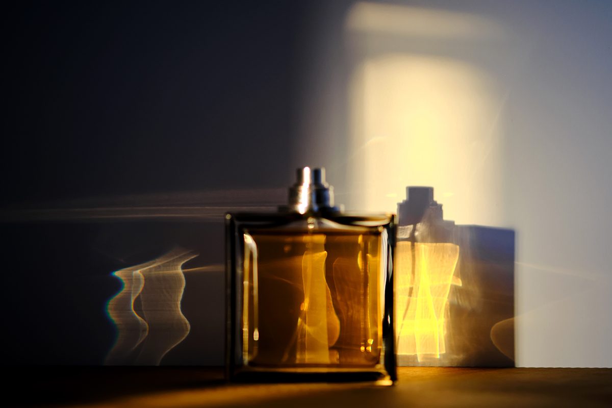 A perfume bottle bathed in a ray of sunlight