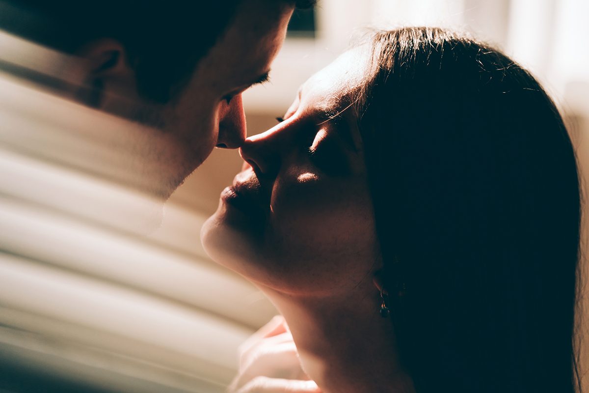 A close-up shot of a couple with their noses touching