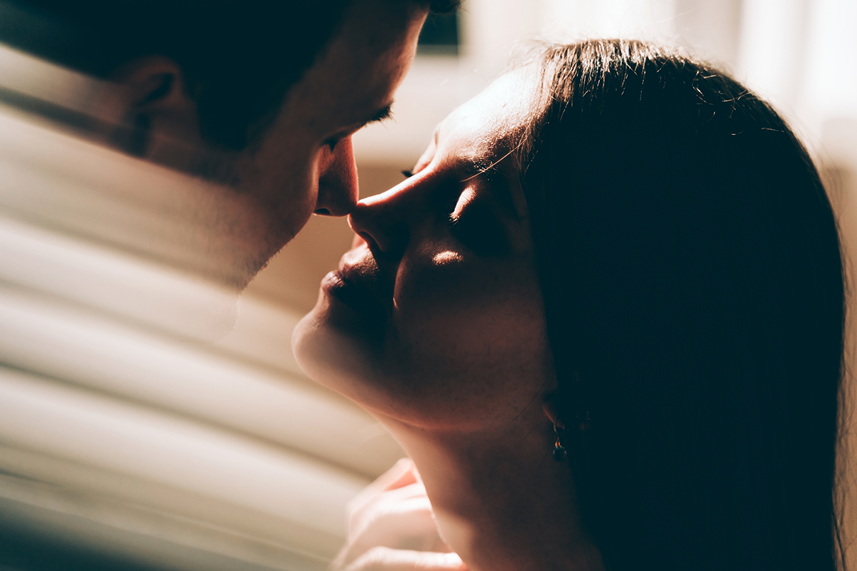 A close-up shot of a couple with their noses touching