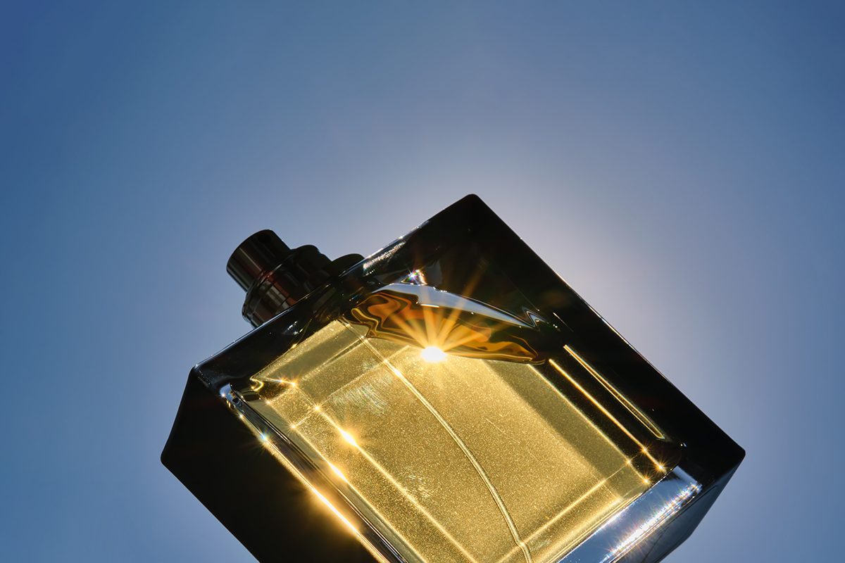 A perfume bottle against a blue background