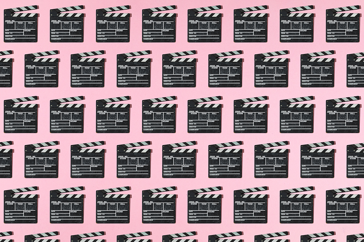 A pattern of clapperboards on a pink background
