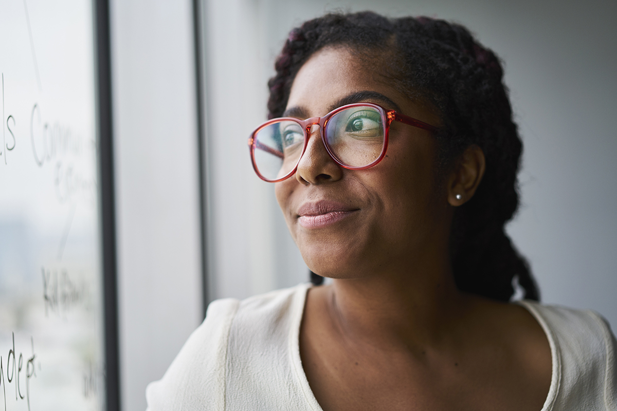 A woman wearing glasses with a red frame