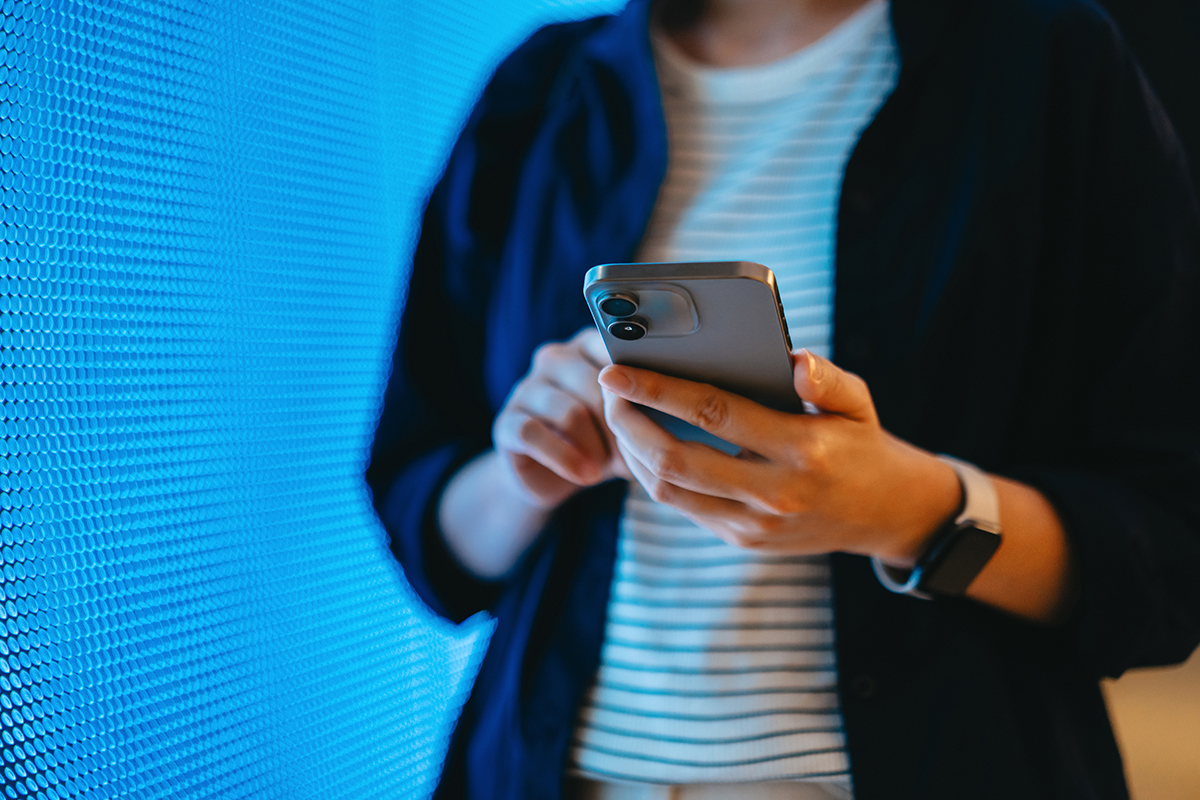 Cropped shot of a person on their phone