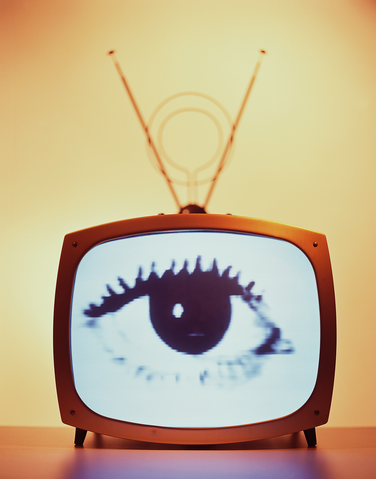 A retro television with a large eye on the screen