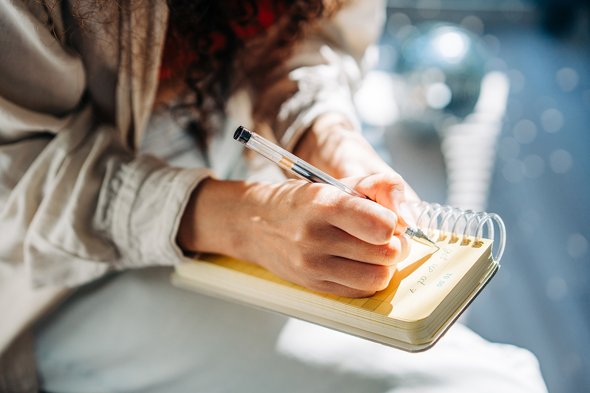 A woman writing in a notebook