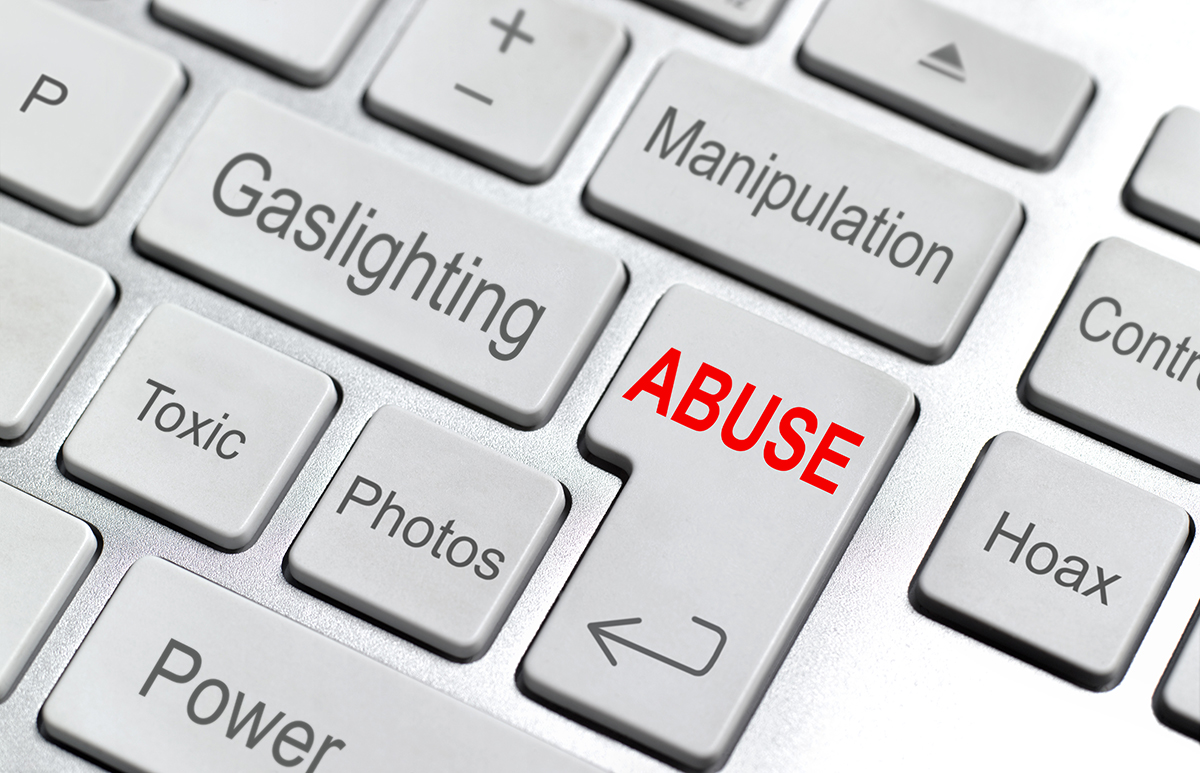 A keyboard with words associated with abuse written on the keys